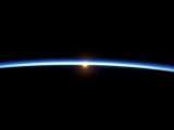 The Thin Line of Earth's Atmosphere and the Setting Sun Photographie