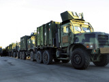Armored Trucks Sit on the Pier at Morehead City, North Carolina, Awaiting Deployment Lámina fotográfica