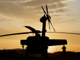 A UH-60L Black Hawk Helicopter Silhouetted by the Setting Sun Photographic Print