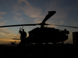 A UH-60 Black Hawk Helicopter on the Flight Line at Sunset Photographic Print