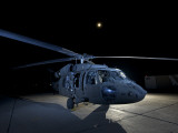 A UH-60 Black Hawk Helicopter Parked on the Flight Line under a Full Moon Photographic Print
