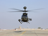 An Oh-58D Kiowa Warrior Hovers over the Flight Line at Camp Speicher, Iraq Photographic Print