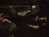 Vacationers Swim with their Pet Dog in the Neversink River Photographie par Maria Stenzel
