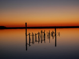 Sunset over Calm Water and a Dilapidated Old Pier Photographic Print by Ross Kelly