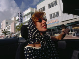 An Artist Drives Down Ocean Drive in South Miami Beach Photographic Print by Maggie Steber