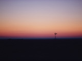A Solitary Windmill Breaks the Flat Horizon of Dawn Photographic Print by George F. Mobley