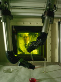 A Man Uses Mechanical Hands to Handle Nuclear Materials Photographic Print by Winfield Parks