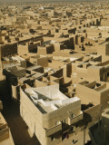 Castellated Walls of Mud Brick Shade Rooftops in Heart of Old Town Photographie par Thomas J. Abercrombie