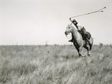 Whirling His Boleadoras, a Man Charges after an Ostrich Photographie par Luis Marden