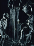 Oilmen Covered in Mud Pull Up a Drill Pipe to Change the Bit Photographic Print by David Boyer