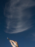 A Girl Pretends to Paint a Cloud in the Sky Photographie par John Burcham