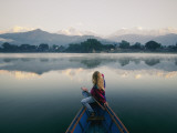 A Woman in a Rowboat Gazes at the Annapurna Range at Dawn Photographie par Skip Brown