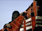 A Veiled Bedouin Woman Peers Through a Slit-Eyed Veil Photographic Print by Thomas J. Abercrombie