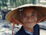 An Elderly Vietnamese Woman in a Native Hat Smiles as She Is Photographed Photographic Print by Steve Raymer
