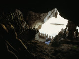 A Woman Kneels to Pray to Buddha in Sacred Cave High Above the Mekong Photographic Print by W.E. Garrett