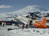Men Leading Sled Dogs to Waiting Transport Plane Photographic Print by David Boyer