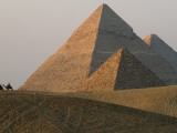 Camel Riders are Dwarfed by the Pyramids of Giza Photographic Print by James L. Stanfield