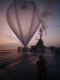 A Naval Hot-Air Balloon Tugs at its Launch Pad on the USS Antietam Photographie par Walter Meayers Edwards