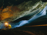 A Cave Explorer Climbs Through One of the Madre De Dios Island Caves Photographie par Carsten Peter