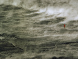 Man Standing in Steaming Rain Falling on Still-Hot Volcanic Lava Photographie par Robert Madden