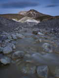 In the Valley of Death, Mountains Loom Behind a Stream Photographic Print by Michael Melford