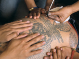 Monks Tatooing at the Wat Bang Phra Buddhist Temple Photographic Print by Alison Wright