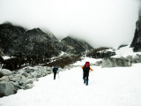 Two Climbers Ascend a Steep Snowfield to Clouds in the Wa Backcountry Photographic Print by Michael Hanson