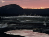 Reflections of a Dying Sun Stain the Firehole River and Steaming Hot Springs Photographic Print by Raymond Gehman