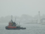 A Tugboat Travels Through Fog Past New London Harbor Light Photographic Print by Todd Gipstein