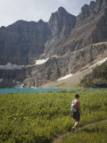 A Girl Hikes to Iceberg Lake in Montana on a Sunny Day Photographic Print by Michael Hanson