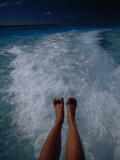 A Woman's Feet Dangle over the Churning Wake of a Motorboat Photographic Print by Jodi Cobb