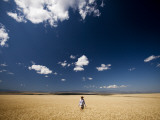 A Girl Wearing a Cowboy Hat Stands in a Wheat Field on a Sunny Day Photographic Print by Michael Hanson