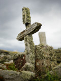 An Old Moss-Covered Cross Stands Amid Rocks in a Graveyard Photographic Print by Jim Richardson