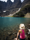A Girl Wearing a Cowboy Hat Enjoys Iceberg Lake in Montana Photographic Print by Michael Hanson