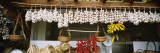 Red Chili Peppers and Garlic Hanging in a Market, Funchal, Madeira, Portugal Kalkomania ścienna autor Panoramic Images