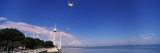 Tower with a Bridge in Background, Vasco De Gama Tower and Bridge, Tagus River, Lisbon, Portugal Wall Decal by Panoramic Images 