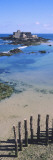 View of Wooden Posts on the Beach with a Fort in the Background, St-Malo, Brittany, France Wall Decal by Panoramic Images 