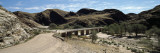 Bridge over Dry Riverbed, Naukluft Mountains, Namib-Naukluft National Park, Hardap Region, Namibia Vinilos decorativos por Panoramic Images Bridge over Dry Riverbed, Naukluft Mountains, Namib-Naukluft National Park, Hardap Region, Namibia Vinilos decorativos por Panoramic Images