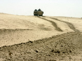 An Amphibious Assault Vehicle Rolls Through a Desert Field North of Fallujah Photographic Print by Stocktrek Images 