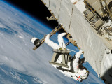 An Astronaut Mission Specialist, Crawls Along a Truss on the International Space Station Photographic Print by Stocktrek Images 