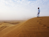 Man Standing on Sand Dune Looking Out on Arabian Desert Photographic Print by Christian Aslund