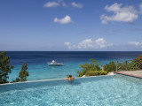 Swimmer in Infinity Pool at Habitat Curacao Dive Resort Near St. Willibrordus Photographic Print by Holger Leue