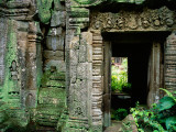 Lichen Covered Carvings Lead to a Doorway at Ta Proh Photographie par Glenn Beanland