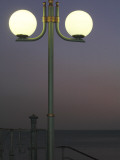 Globe Lamps Overlooking Platja Del Miracle Beach at Dusk Fotografisk trykk av David Borland