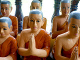 Statuettes of Buddhist Monks at Prayer Photographic Print by Philip Game