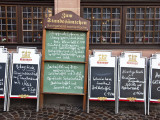 Menu Boards Outside Restaurants on Romerberg, the Old Central Square Fotografiskt tryck av Richard l'Anson Menu Boards Outside Restaurants on Romerberg, the Old Central Square Fotografiskt tryck av Richard l'Anson