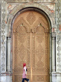 Young Turkish Woman Walking Past an Ornate Doorway in Ortakoy Photographic Print by Tim Hughes