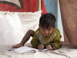 Boy Writing in Notebook Photographic Print by April Maciborka