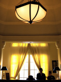 Concierge at Colonial-Era Raffles Hotel Le Royal Photographic Print by Antony Giblin