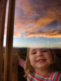 Portrait of Young Girl at Window with Reflection of Clouds at Sunset Impressão fotográfica por Will Salter Portrait of Young Girl at Window with Reflection of Clouds at Sunset Impressão fotográfica por Will Salter